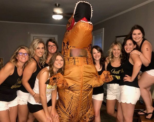T-Sex inflatable dinosaur at smiling bachelorette party